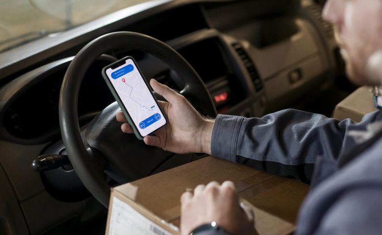 homem no celular analisando Benefícios da logística porta a porta